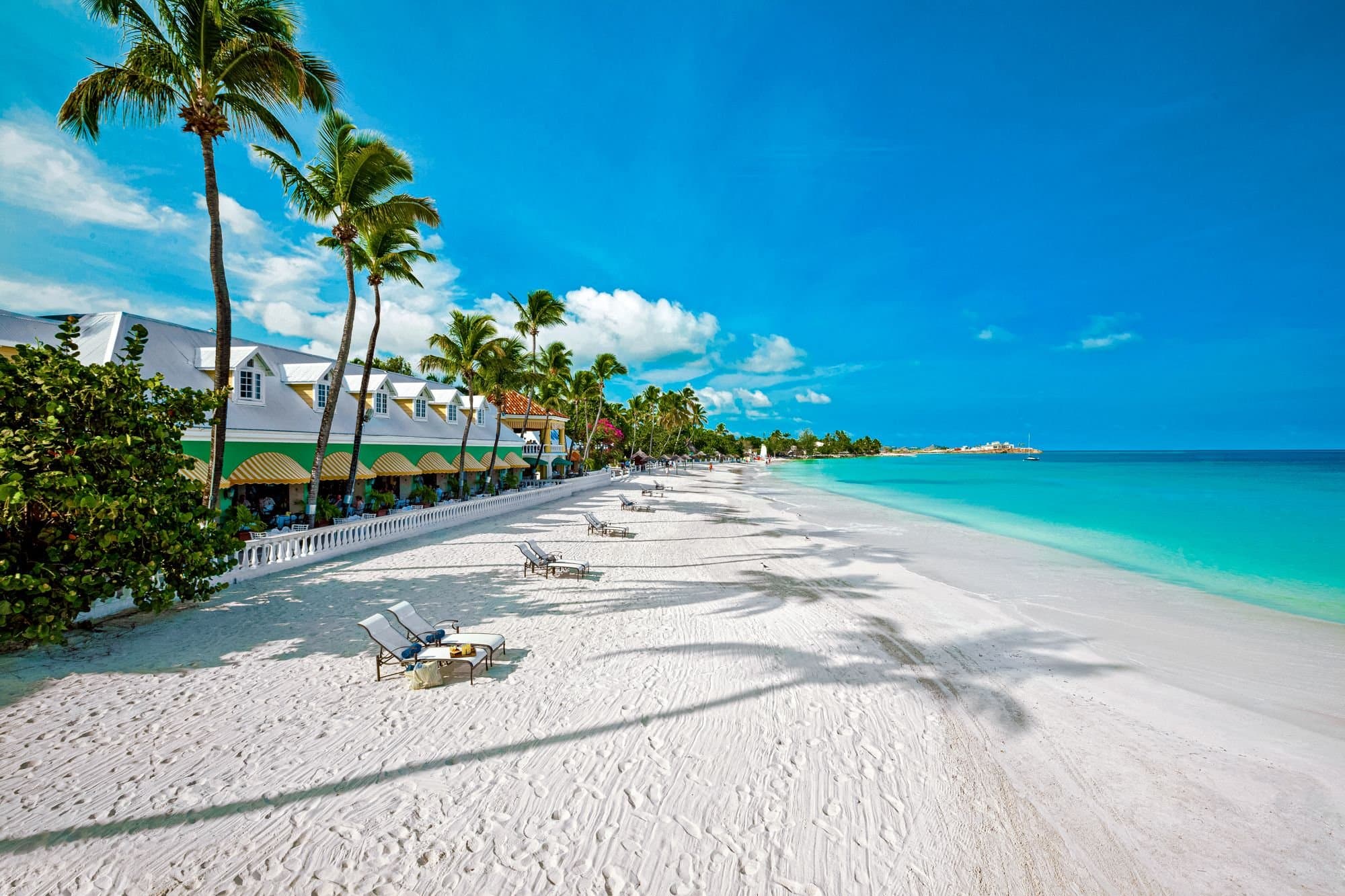 White-sand beach and turquoise water at a beachfront resort in Antigua