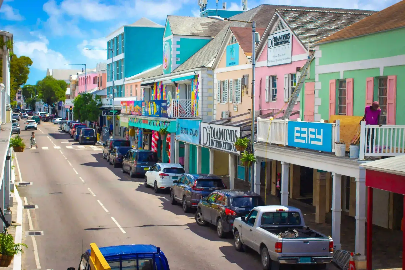 Cars parked along Bay Street in downtown Nassau, The Bahamas