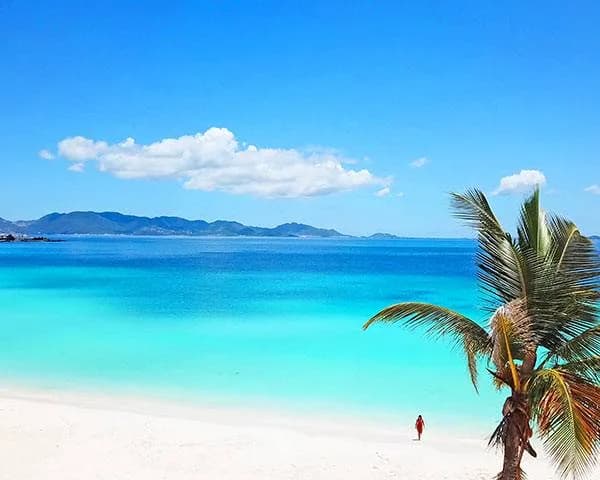 A long arc of sand at Rendezvous Bay with St. Martin on the horizon