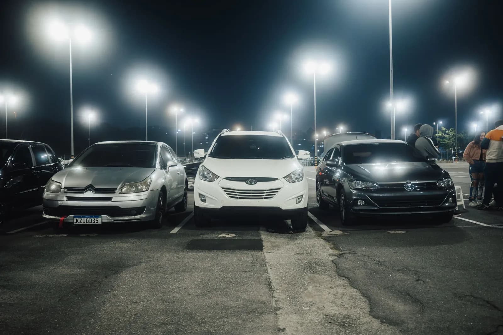 Cars parked under lights in an Aruba lot at night