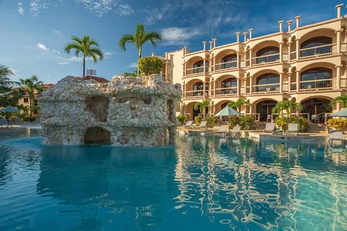 Stone-clad beachfront resort with a lagoon pool and grotto on Ambergris Caye