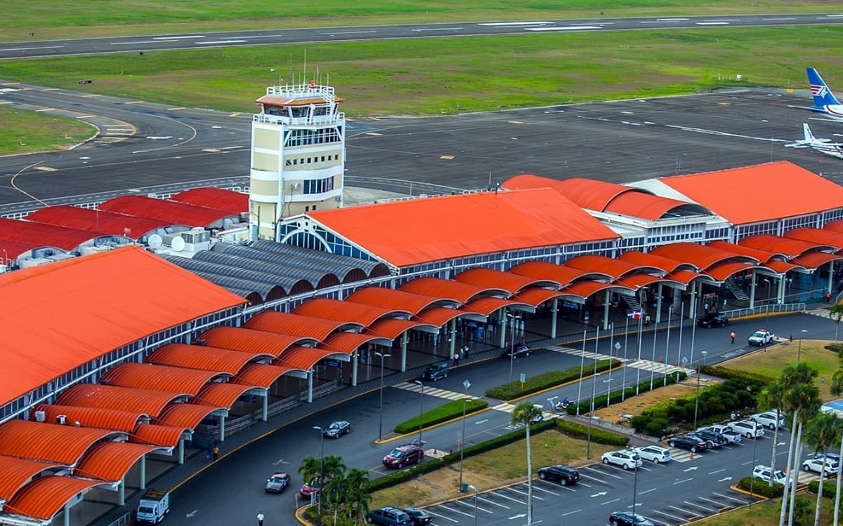 Departure hall of Punta Cana International Airport with passengers at check-in, Dominican Republic