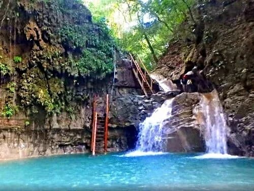 Visitors jumping into a limestone pool at the 27 Waterfalls of Damajagua near Puerto Plata, Dominican Republic
