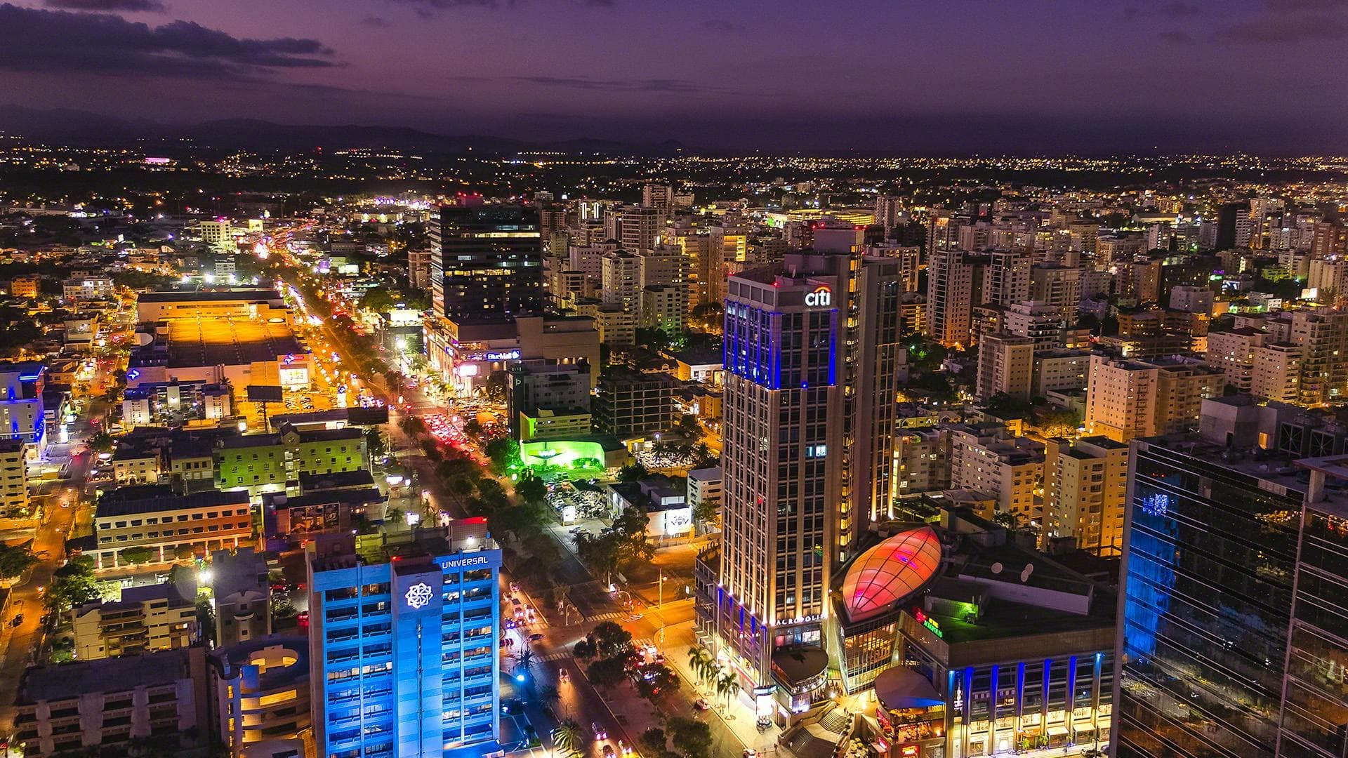 Illuminated skyline of Santo Domingo at dusk reflected on the Caribbean Sea, Dominican Republic