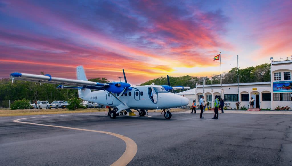 Twin-prop aircraft on the apron at Maurice Bishop International Airport at sunset, Grenada
