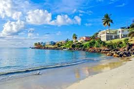 Calm turquoise water lapping the long white sweep of Grand Anse Beach near St. George's, Grenada