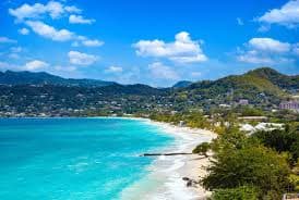 Beachfront resorts lining the white sand and calm bay of Grand Anse, southwest Grenada