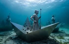 Snorkeller above the ring of human figures of the Underwater Sculpture Park off Grenada's west coast