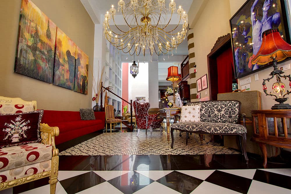An ornate boutique hotel lobby with a crystal chandelier in Old San Juan