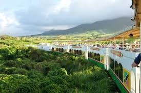 St. Kitts Scenic Railway train running past green sugar-cane country