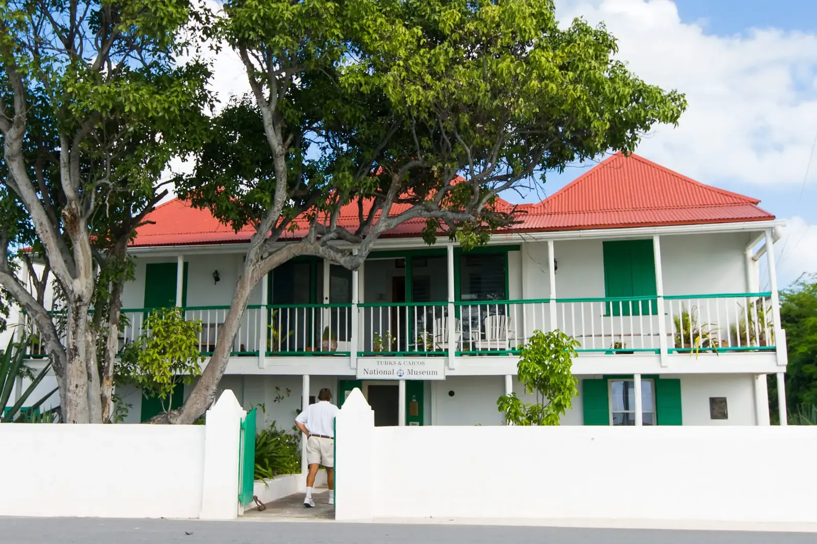 The Turks & Caicos National Museum, a white colonial building with a red roof and green shutters in Cockburn Town, Grand Turk