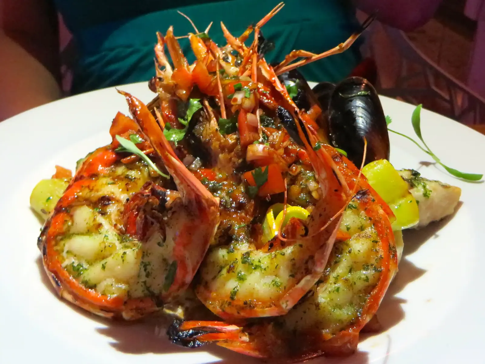 Grilled seafood platter with shellfish and mussels in a herb sauce