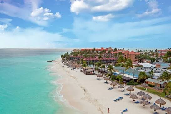 Relaxing on a white-sand Aruba beach with calm turquoise water