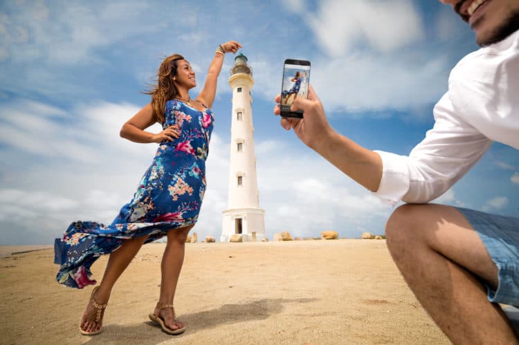 A couple photographing at the California Lighthouse on the northern tip of Aruba