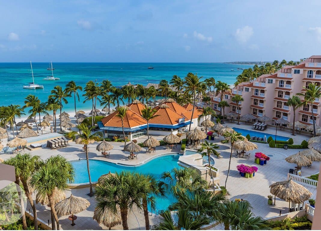 Resort buildings with orange roofs and pools near Oranjestad, Aruba
