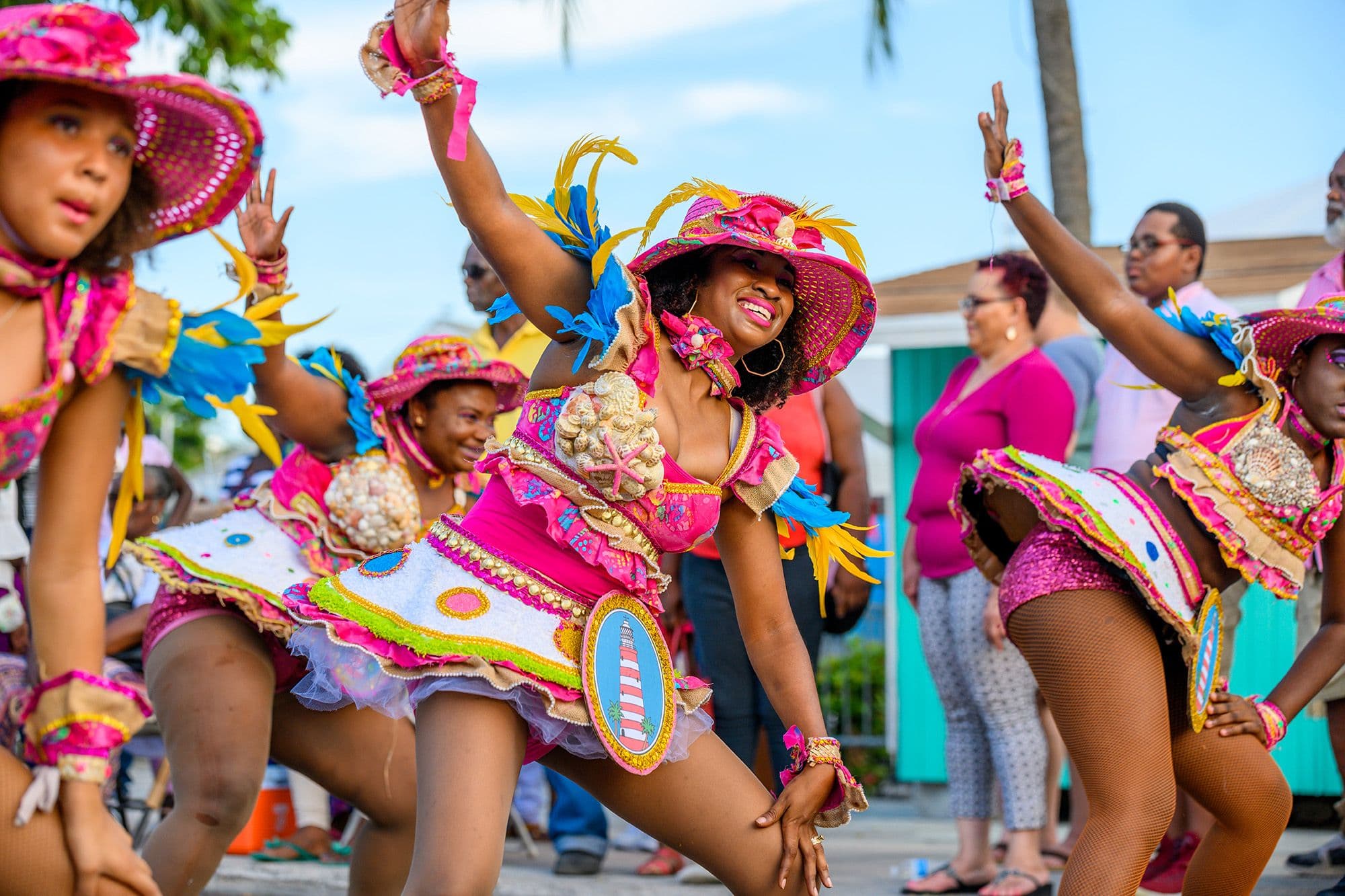 Performers in vibrant sequinned costumes dancing and parading through the streets during the Junkanoo festival in Nassau, Bahamas
