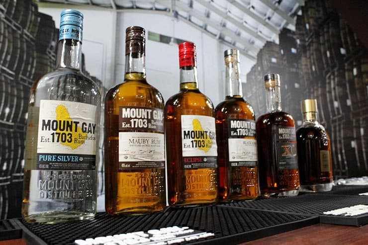 A lineup of Mount Gay rum bottles on a bar during a distillery tasting in Barbados