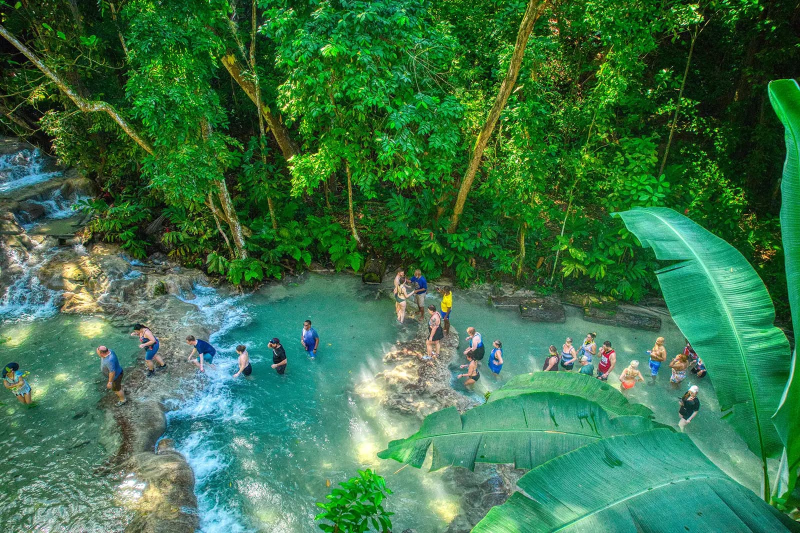Visitors climbing the tiered cascades of Dunn's River Falls through turquoise pools near Ocho Rios, Jamaica