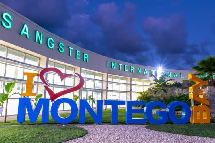 The glowing 'I Love Montego Bay' sign lit up at dusk outside Sangster International Airport, Jamaica