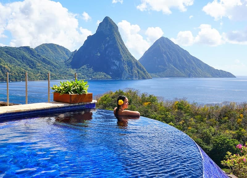 View of the twin Pitons, Gros Piton and Petit Piton, rising across the bay from an infinity pool near Soufrière, Saint Lucia