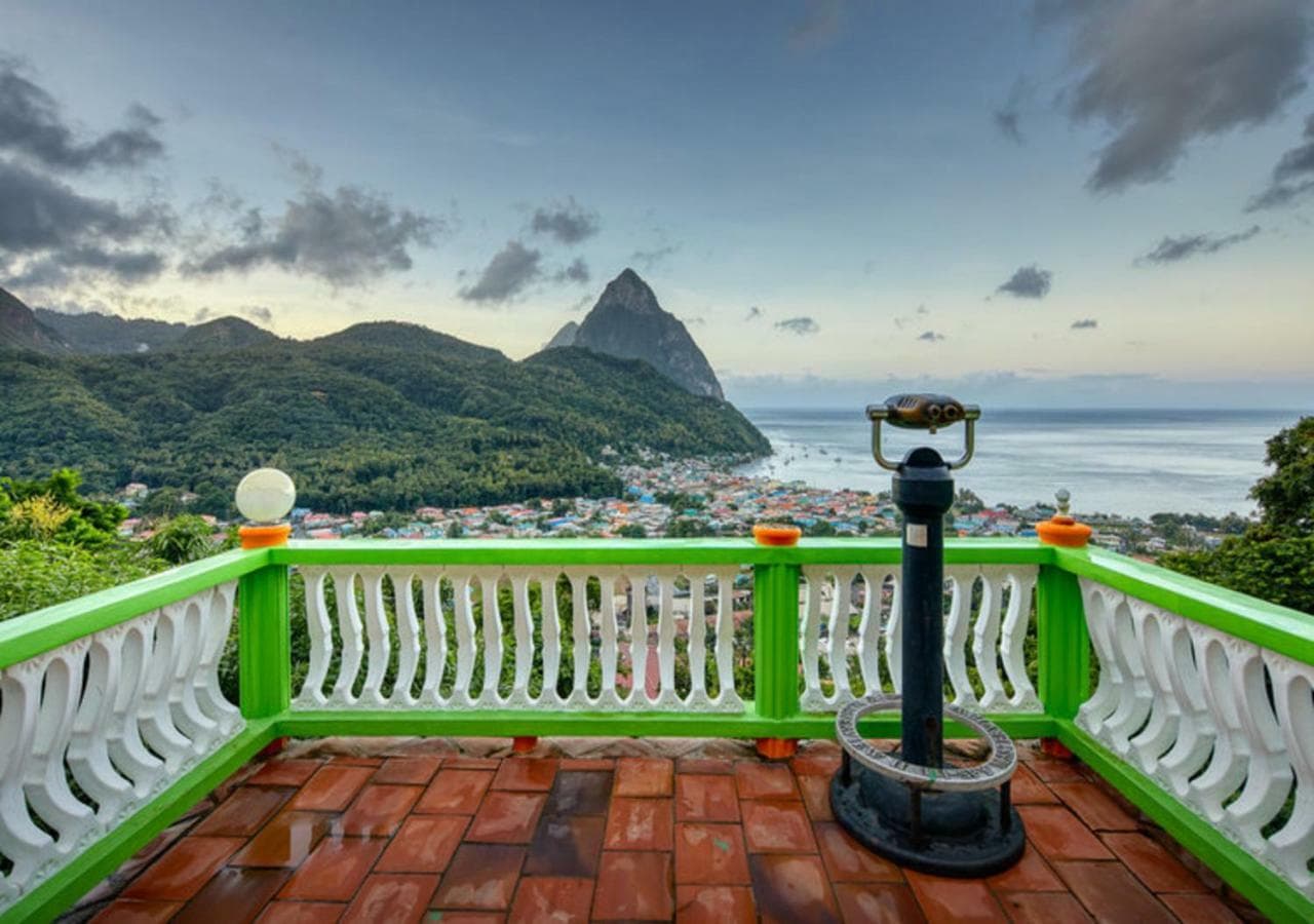 Hillside resort terrace with a telescope overlooking Soufrière town and Petit Piton, southwest Saint Lucia