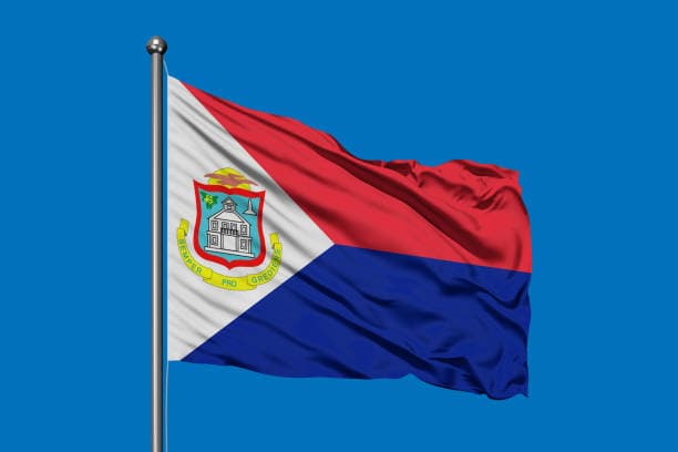 Flag of Sint Maarten, red and blue bands with a white triangle and coat of arms