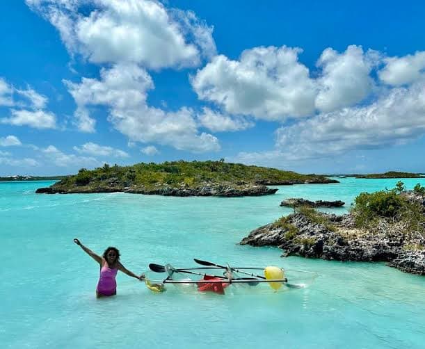 Visitor with a clear kayak in the pale-turquoise lagoon of Chalk Sound, Providenciales