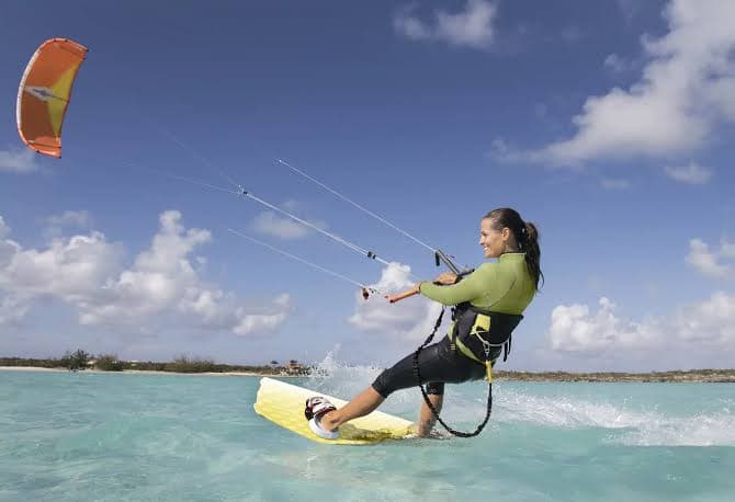Kiteboarder skimming the flat shallow water at Long Bay Beach, Providenciales
