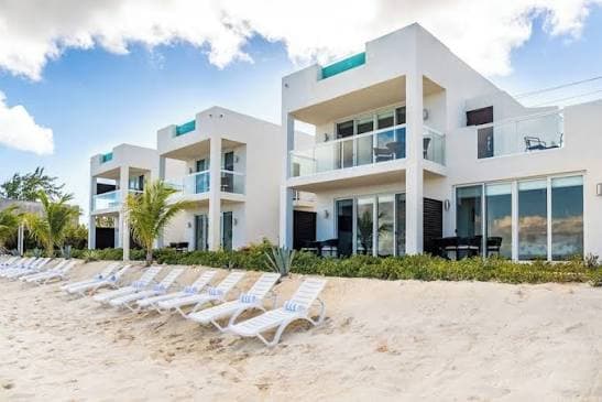 Resort pool framed by palms and low-rise buildings on Providenciales
