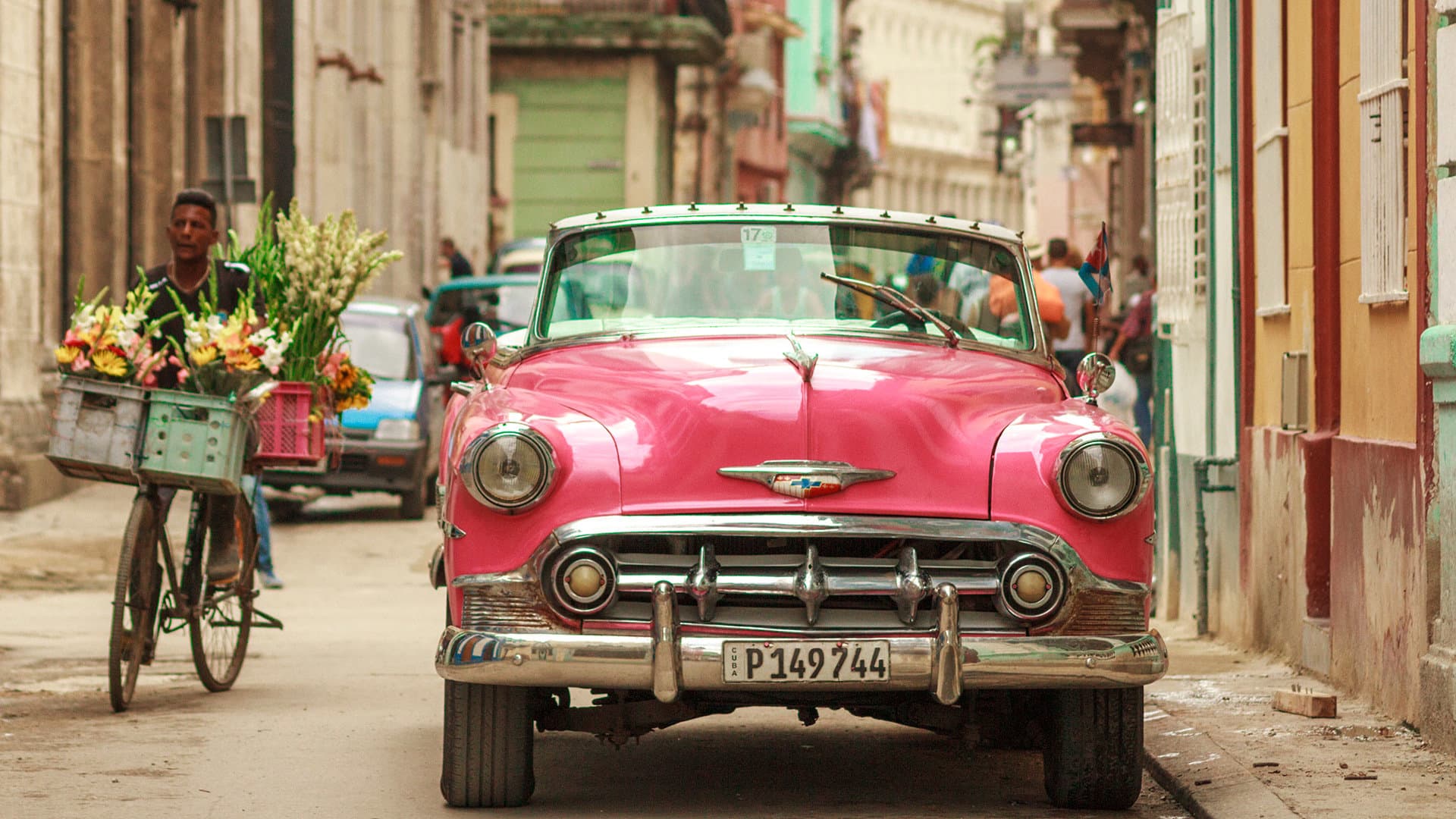 Classic car cruising a Caribbean street